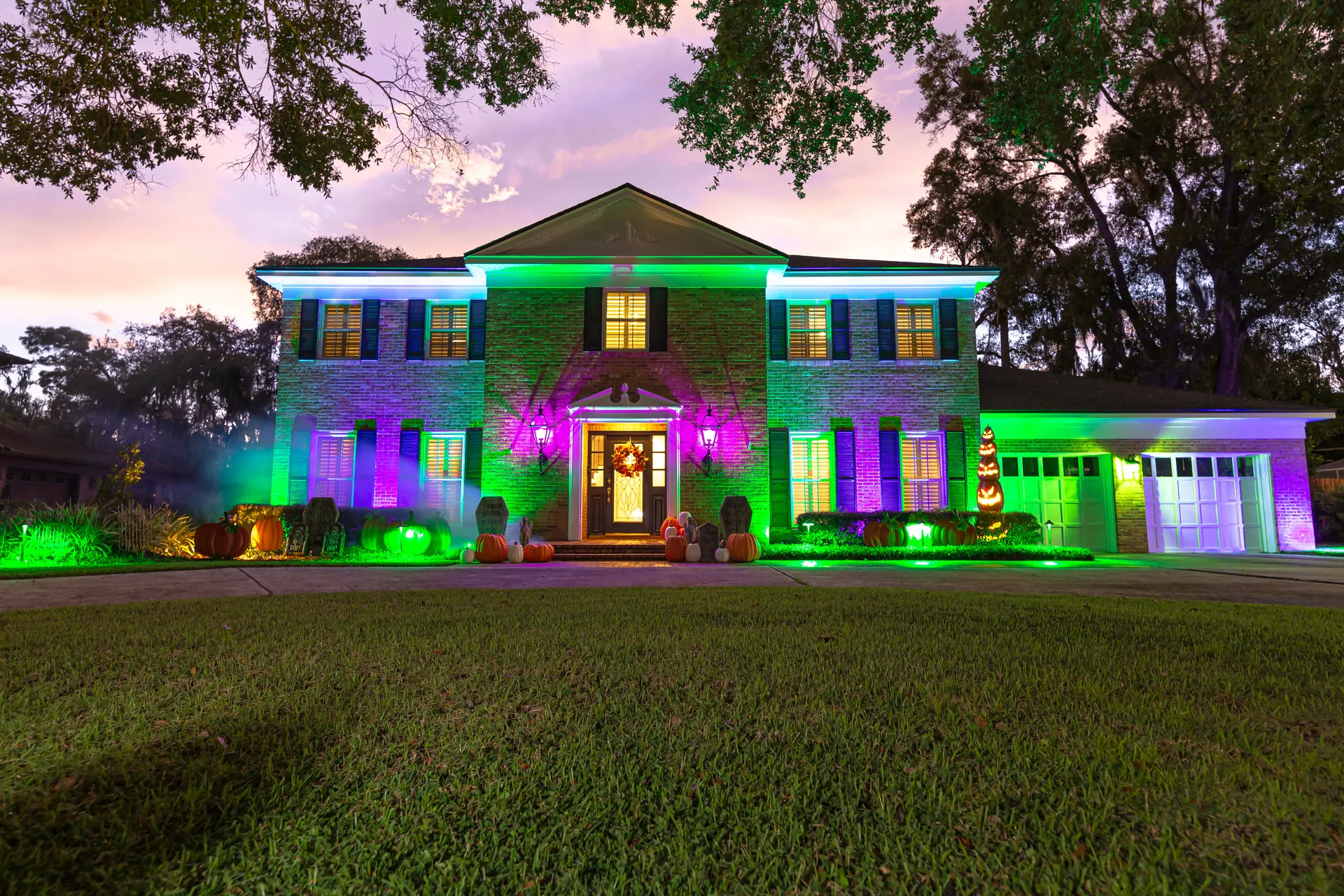 Full brick colonial color-wash at dusk, dramatic sky