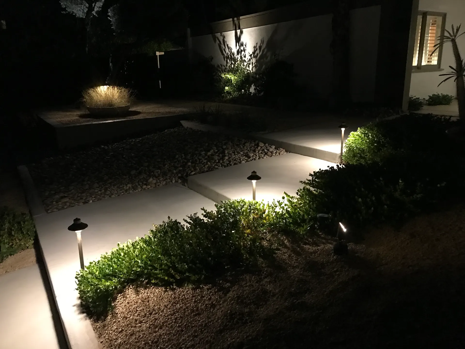 Night modern entry with glare-free path lights and uplit grasses