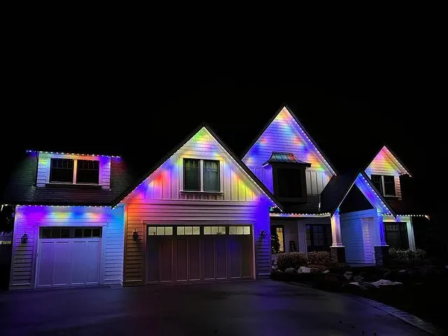 Multi-gable home with vivid RGBW rainbow rooflines, holiday color showcase