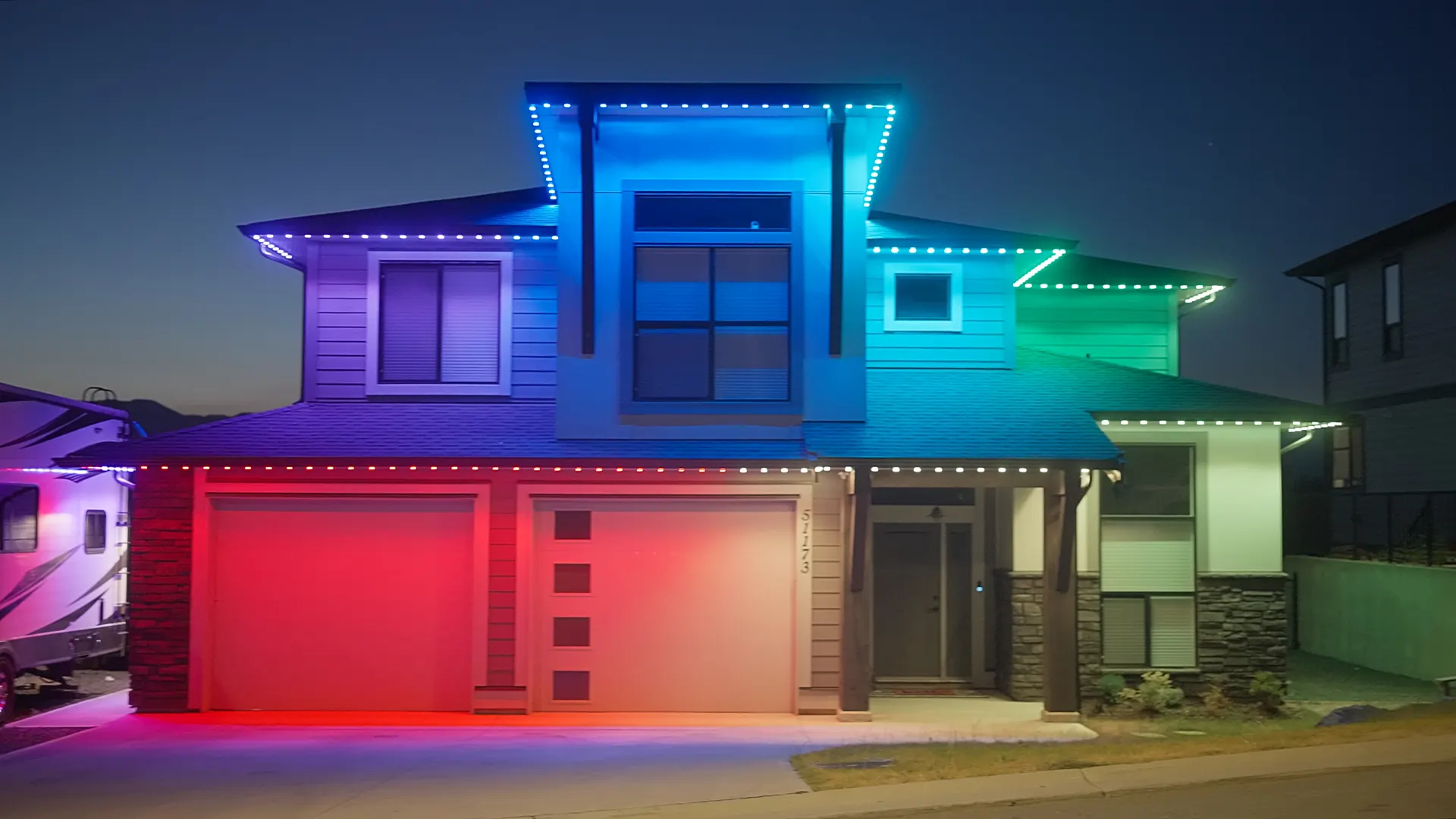 Modern home outlined in red blue green multicolor zones, crisp clean dusk shot