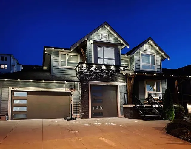 Modern home at dusk with warm white permanent lighting along the roofline