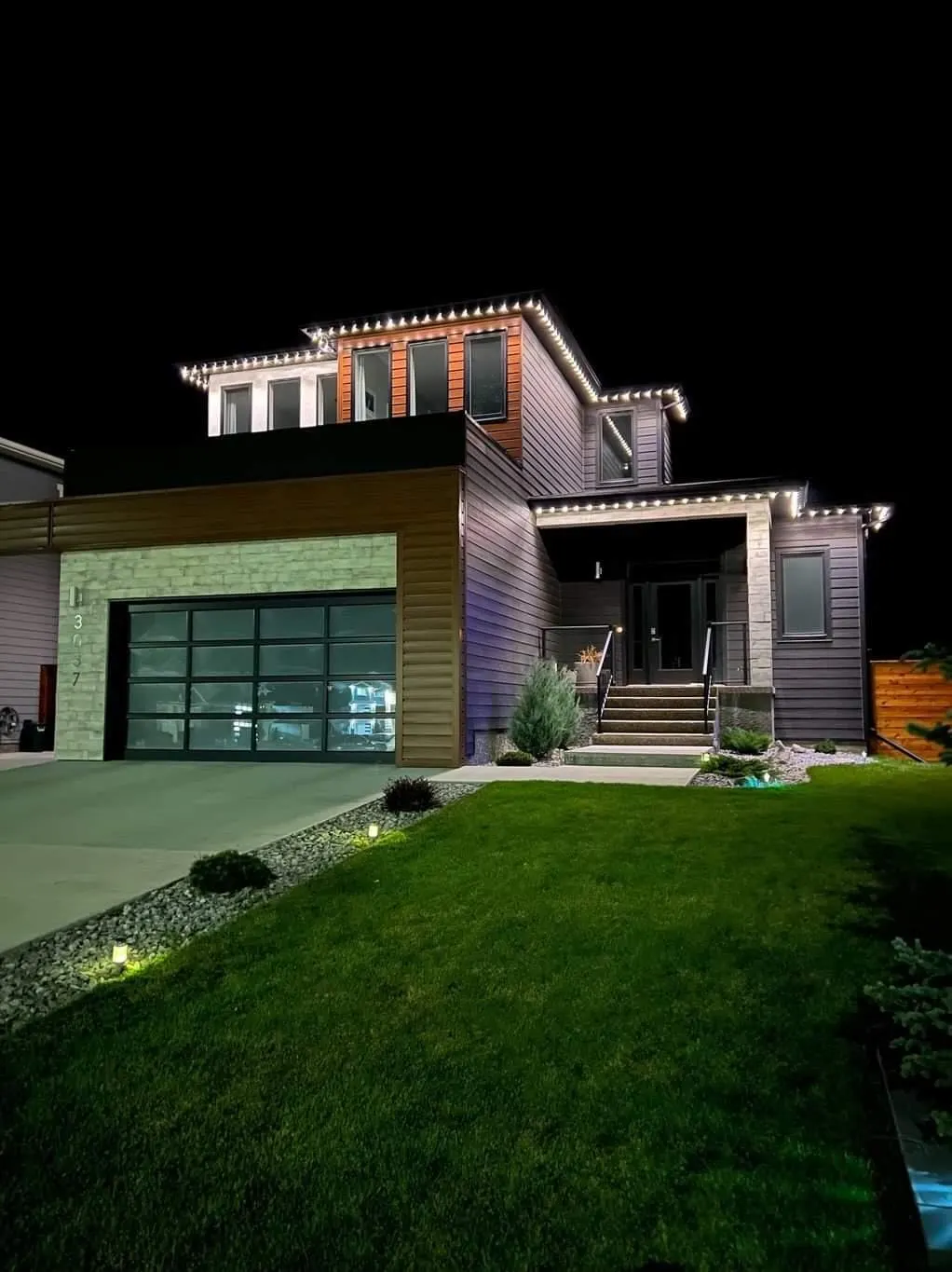 Modern home warm white rooflines plus subtle purple wash, night, path lights